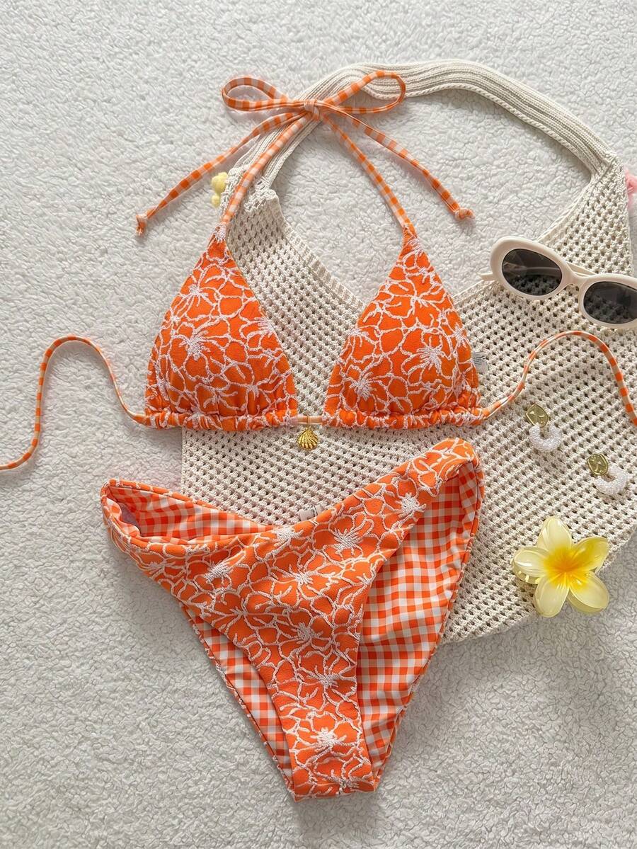 Women's black textured plaid 2-piece bikini set featuring a halter neckline, wireless triangle cups with removable padding, and mid-waist bottoms.