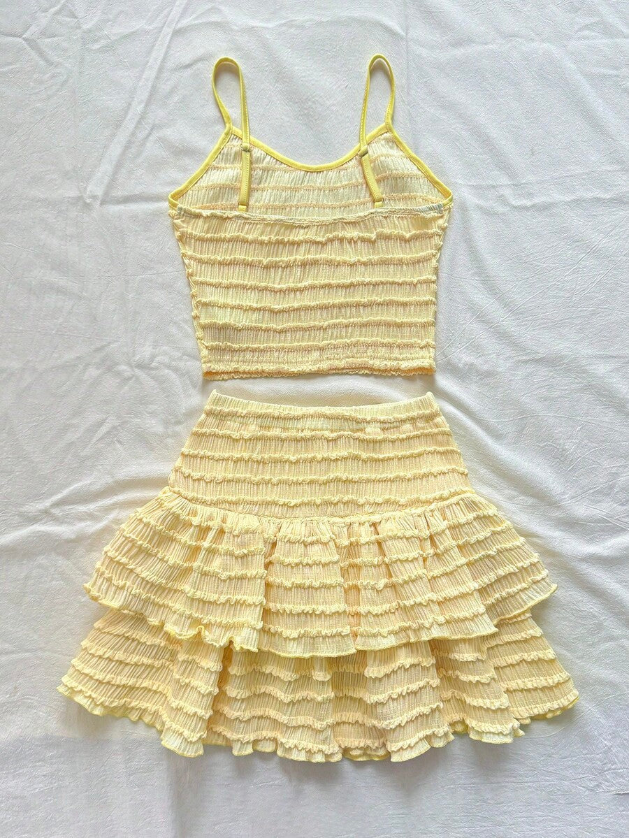 Tween girls solid color two-piece vacation outfit featuring a spaghetti strap camisole short top and a tiered skirt in soft knitted fabric.