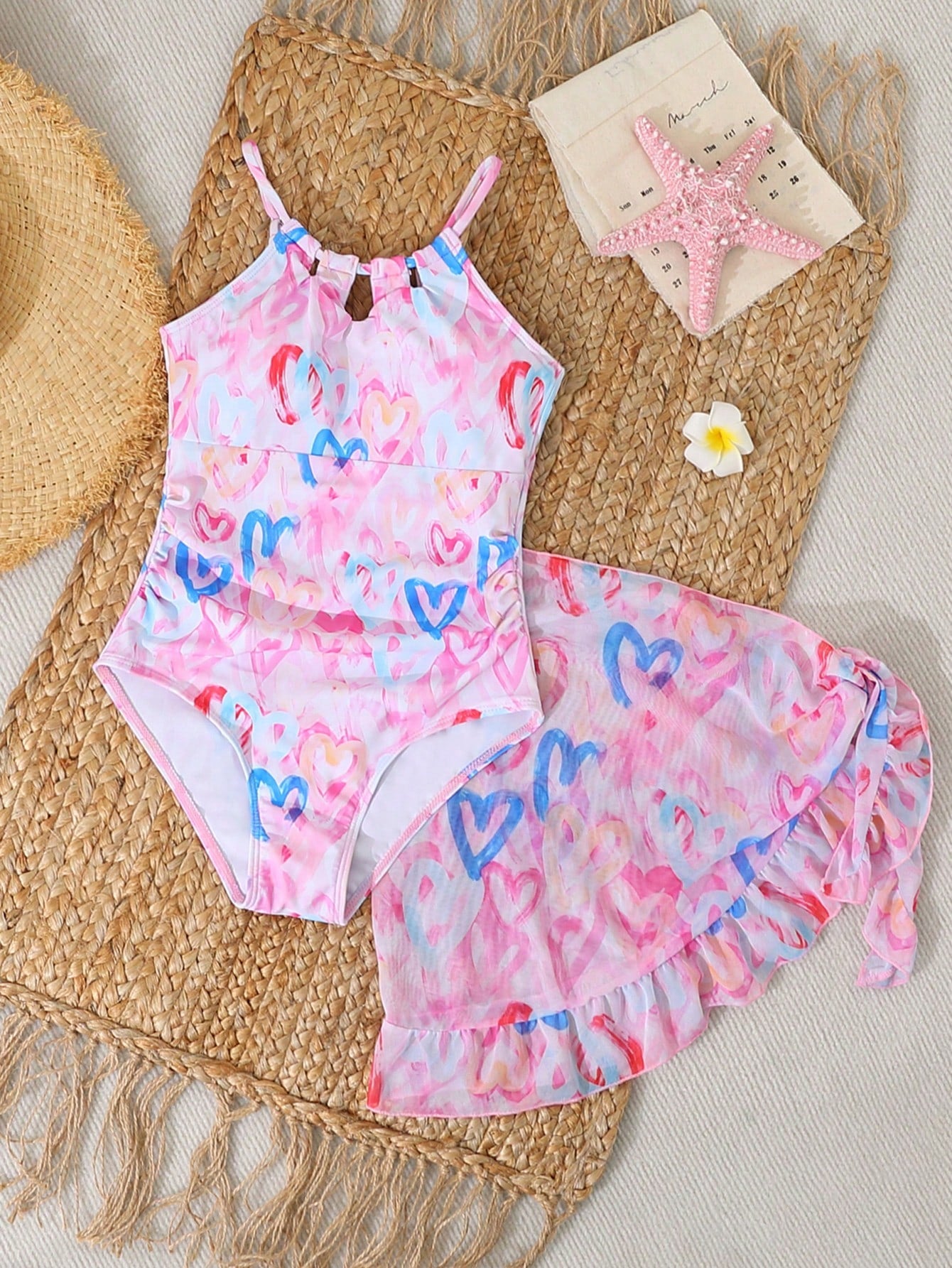 Girls black and white one-piece swimsuit set with cut-out detail, spaghetti straps, sleeveless fitted design, and matching skirt bottom for vacation swimwear.