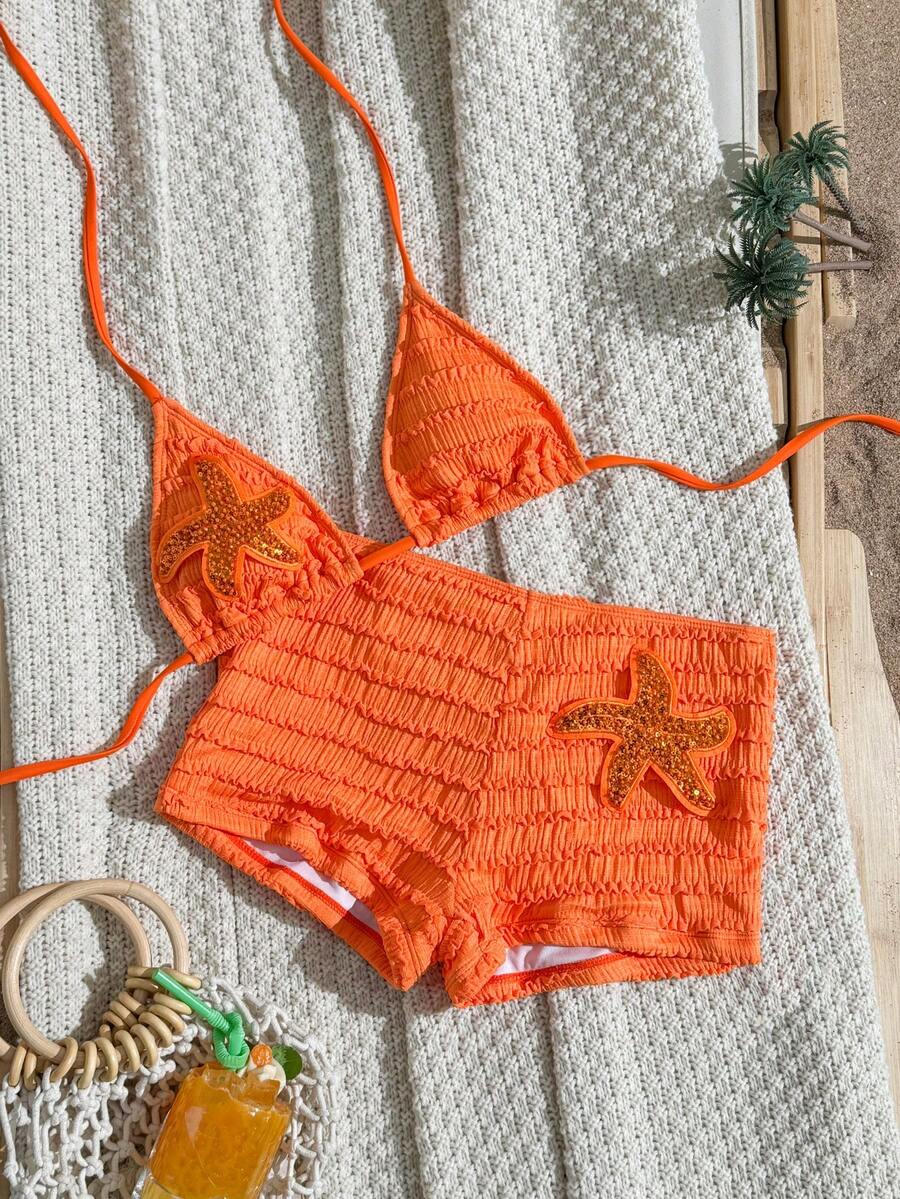 Women's apricot two-piece swimsuit set with a halter tie-back top and matching high stretch shorts.