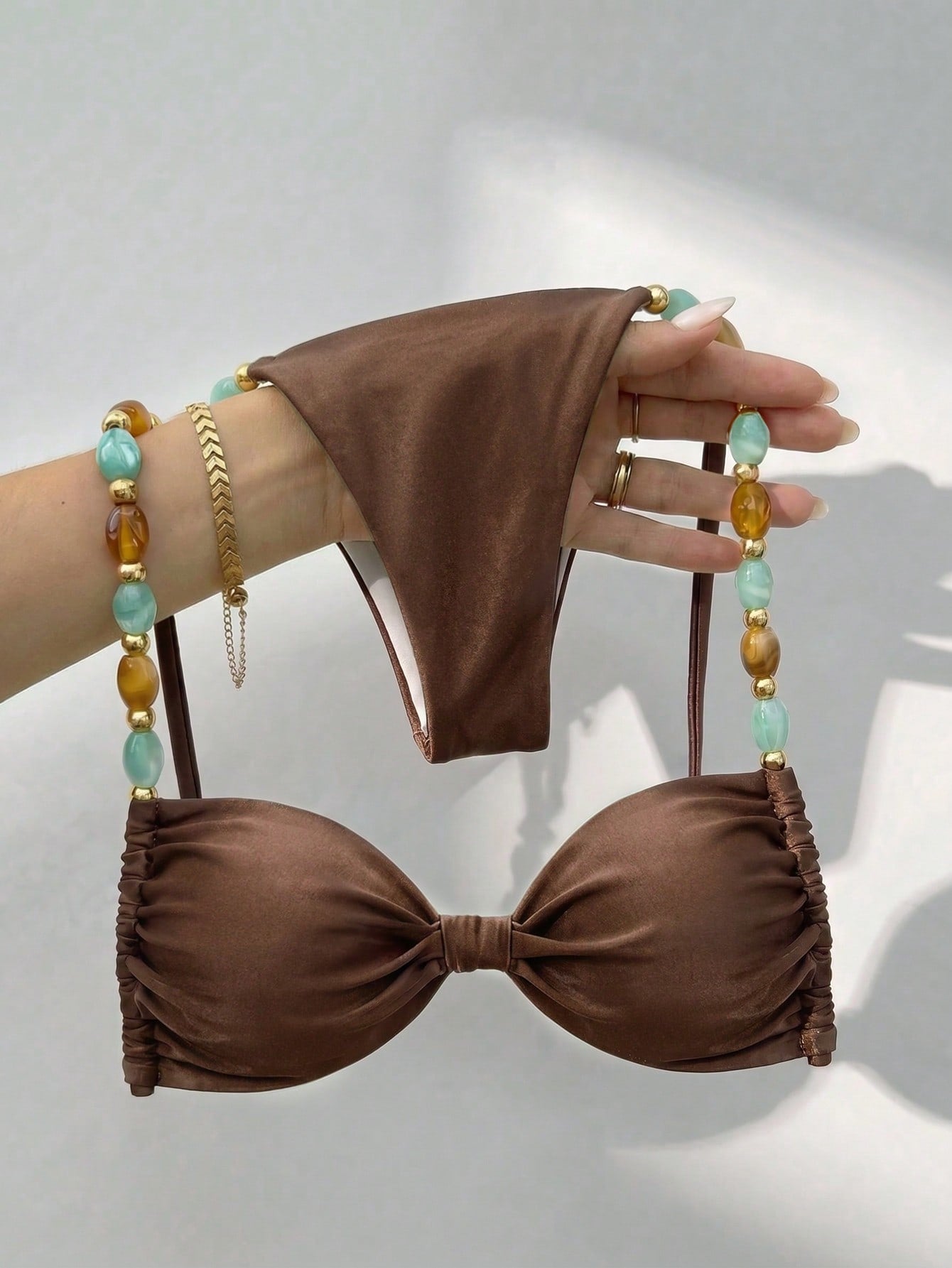 Women's green halter neck bikini set featuring color-block beaded shoulder straps, back tie detail, and high cut bottoms.