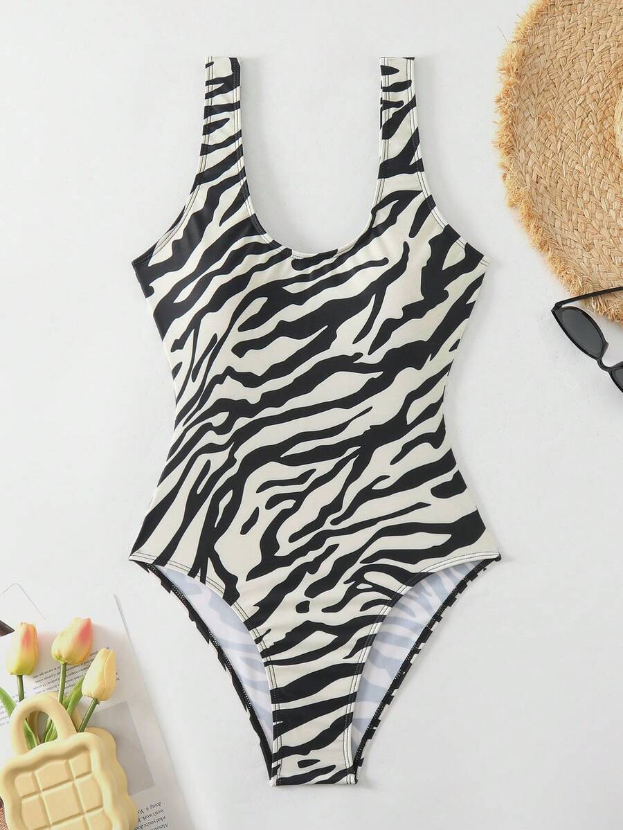 Women's solid color one-piece swimsuit featuring a backless scoop neck design and high cut fit