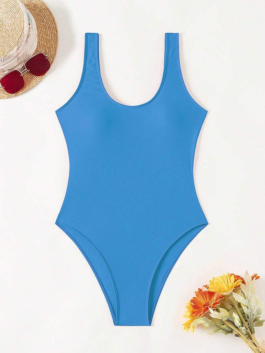 Women's solid color one-piece swimsuit featuring a backless scoop neck design and high cut fit