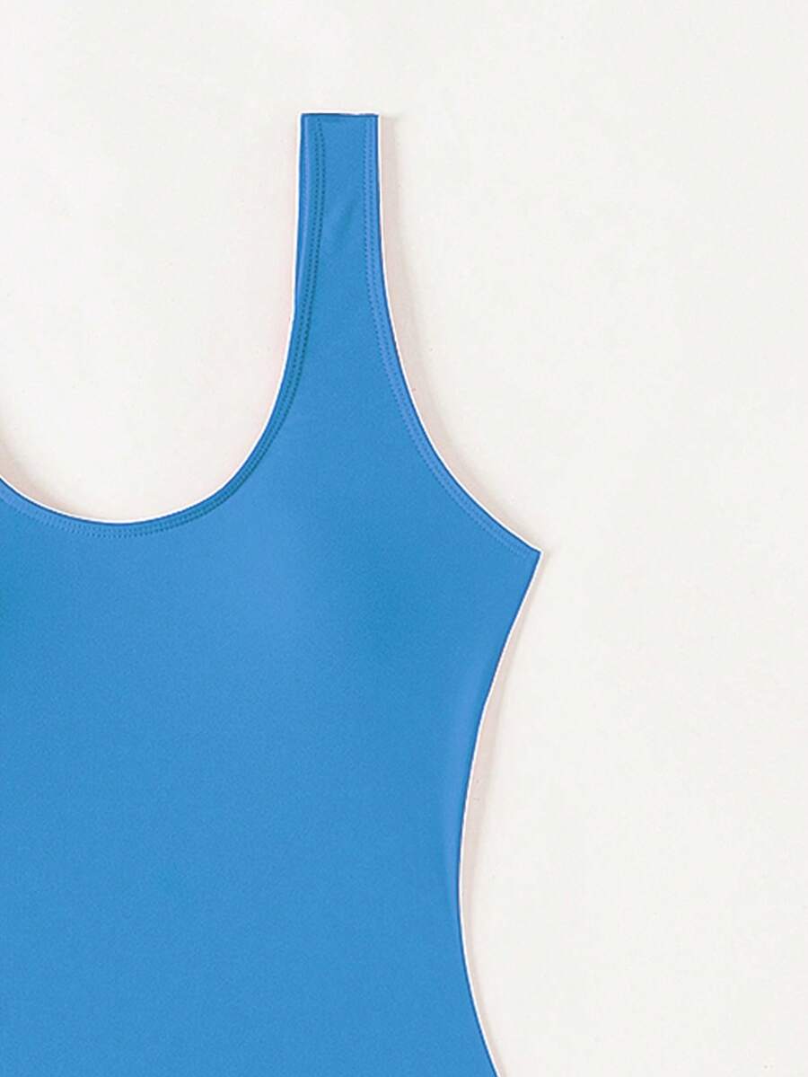 Women's solid color one-piece swimsuit featuring a backless scoop neck design and high cut fit