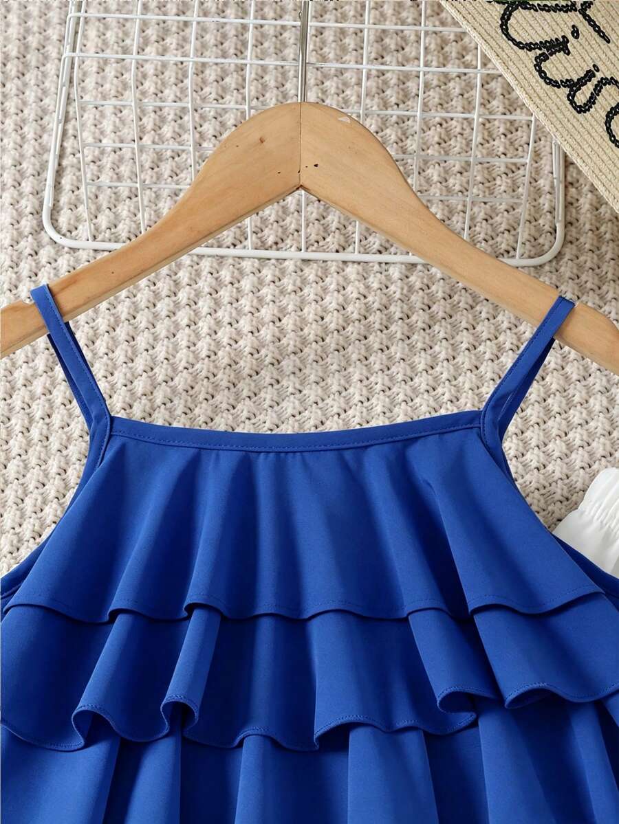 Tween girls blue 2-piece vacation outfit set featuring a tiered ruffle spaghetti strap camisole and loose high-waist pants.