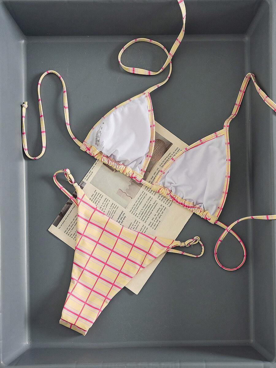 Multicolor bohemian bikini set for women featuring a backless halter top with knot details and high cut swimsuit bottoms.