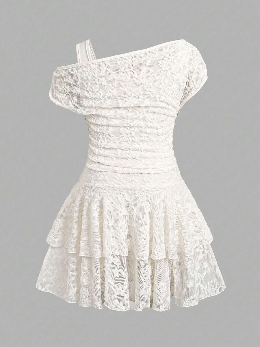 Tween girl wearing an apricot asymmetric skater dress with ruffle and applique details for party and formal occasions.