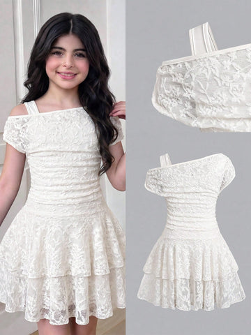 Tween girl wearing an apricot asymmetric skater dress with ruffle and applique details for party and formal occasions.