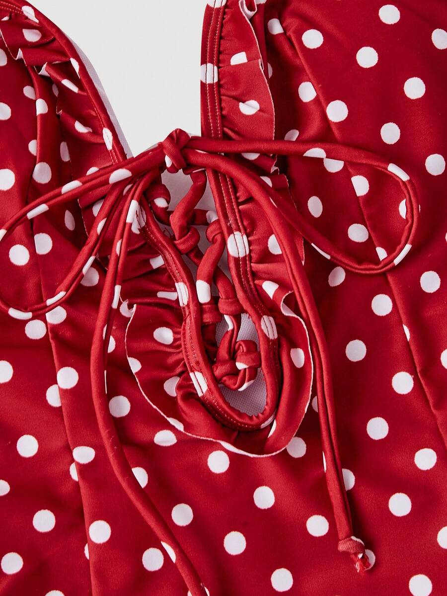 Women's strawberry print one-piece swimsuit featuring ruffle details, front-tie design, backless criss-cross straps, and triangle wireless cups.