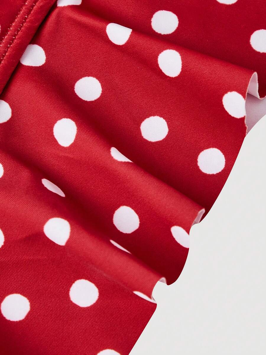 Women's strawberry print one-piece swimsuit featuring ruffle details, front-tie design, backless criss-cross straps, and triangle wireless cups.