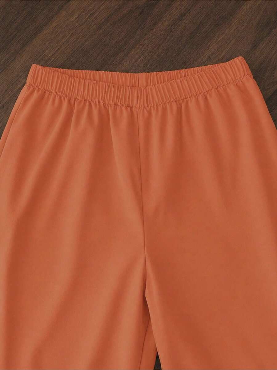 Tween girls casual 2-piece set featuring an apricot woven camisole crop top with back shirring and matching high-waisted loose long pants.