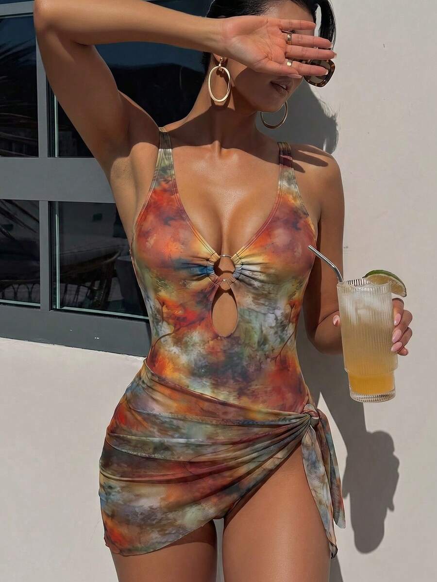 Women's black floral print plunge neck one-piece swimsuit featuring cut-out detail paired with a matching knee-length mesh cover-up skirt