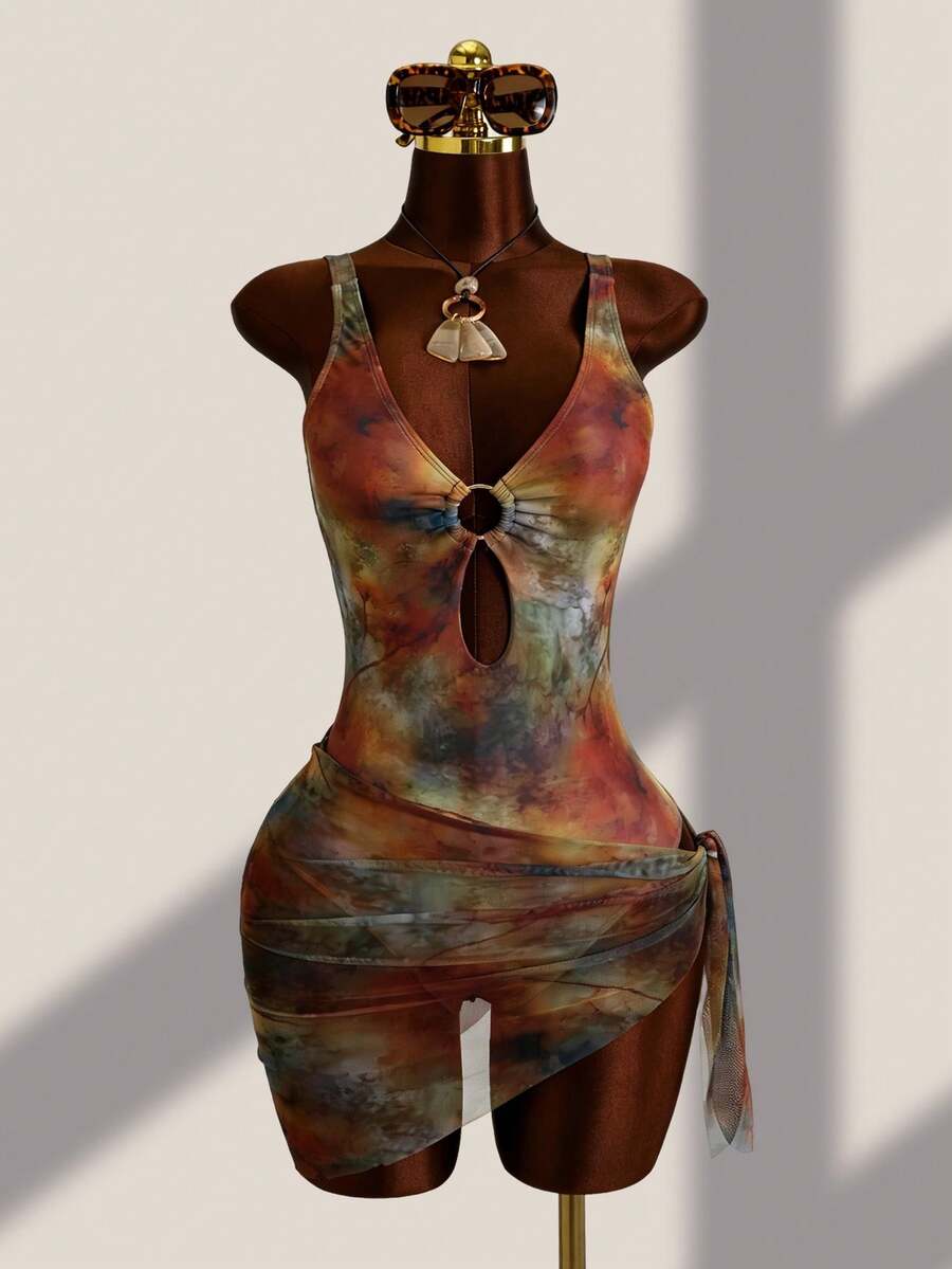 Women's black floral print plunge neck one-piece swimsuit featuring cut-out detail paired with a matching knee-length mesh cover-up skirt