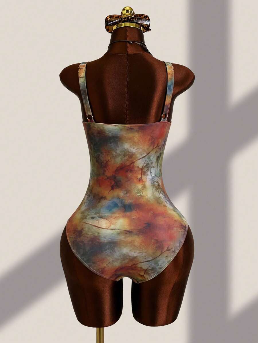 Women's black floral print plunge neck one-piece swimsuit featuring cut-out detail paired with a matching knee-length mesh cover-up skirt