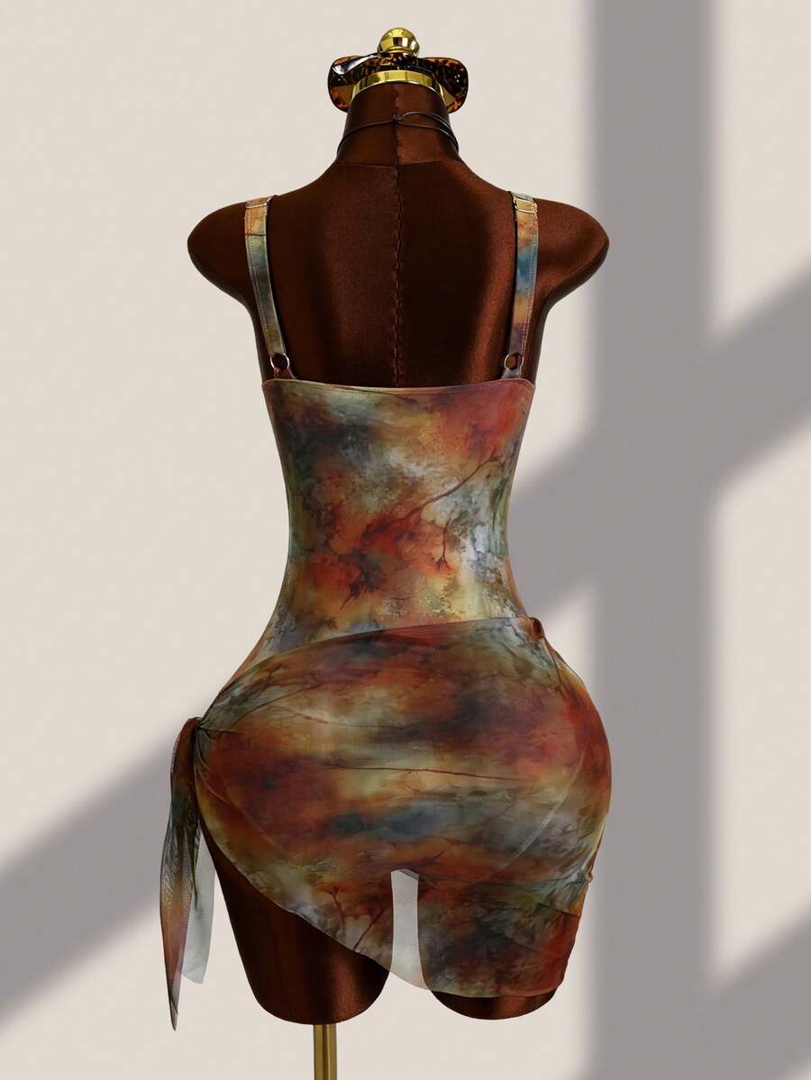Women's black floral print plunge neck one-piece swimsuit featuring cut-out detail paired with a matching knee-length mesh cover-up skirt
