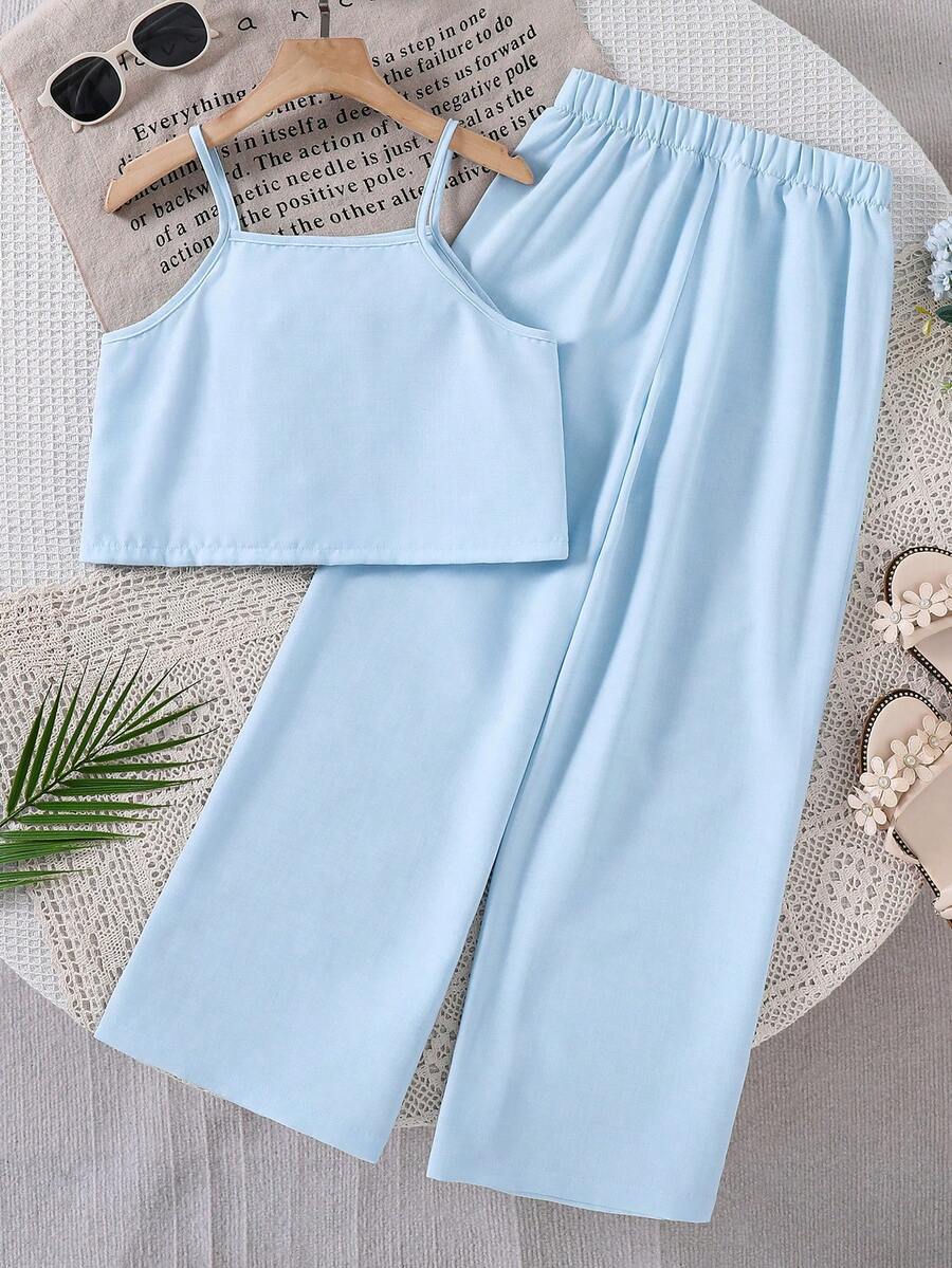 Tween girls blue 2-piece vacation outfit set featuring a tiered ruffle spaghetti strap camisole and loose high-waist pants.