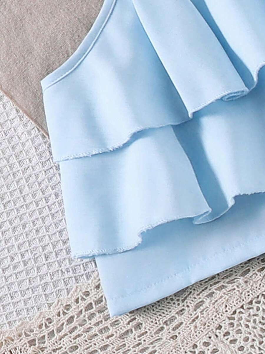 Tween girls blue 2-piece vacation outfit set featuring a tiered ruffle spaghetti strap camisole and loose high-waist pants.