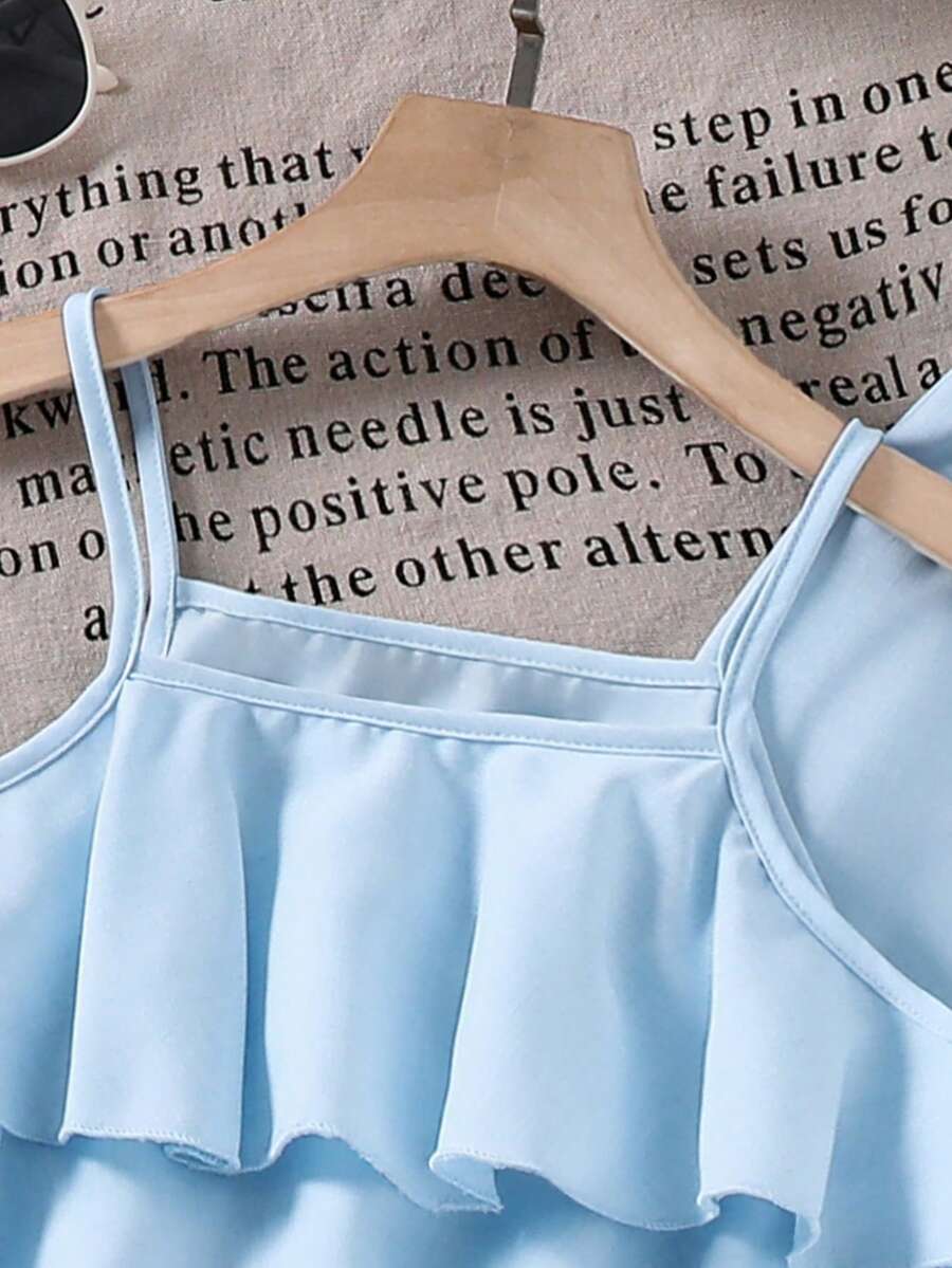Tween girls blue 2-piece vacation outfit set featuring a tiered ruffle spaghetti strap camisole and loose high-waist pants.