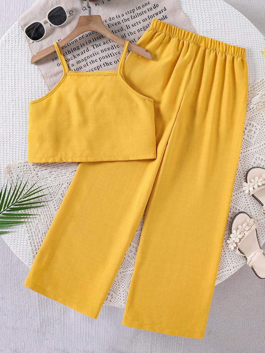 Tween girls blue 2-piece vacation outfit set featuring a tiered ruffle spaghetti strap camisole and loose high-waist pants.