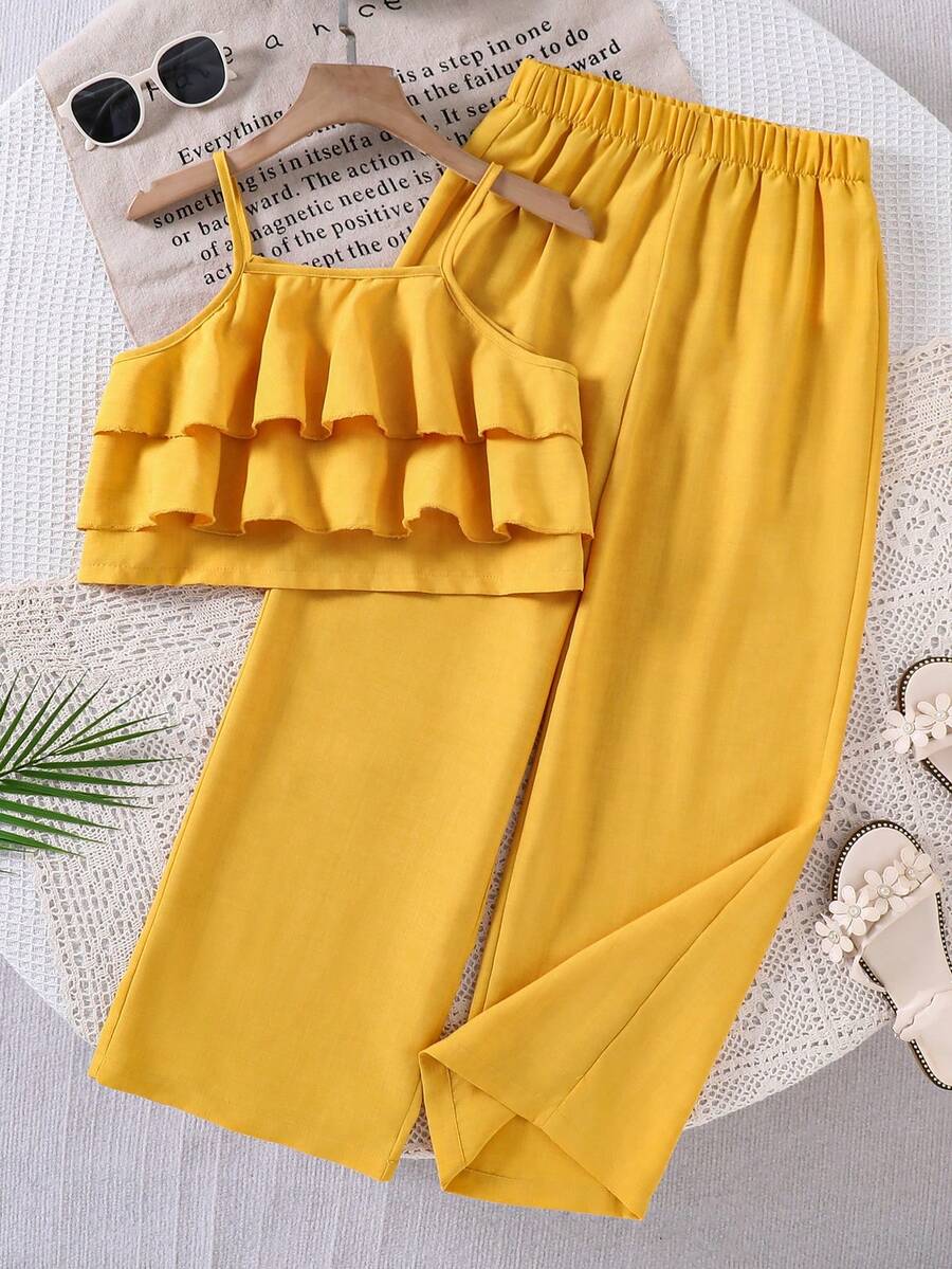 Tween girls blue 2-piece vacation outfit set featuring a tiered ruffle spaghetti strap camisole and loose high-waist pants.