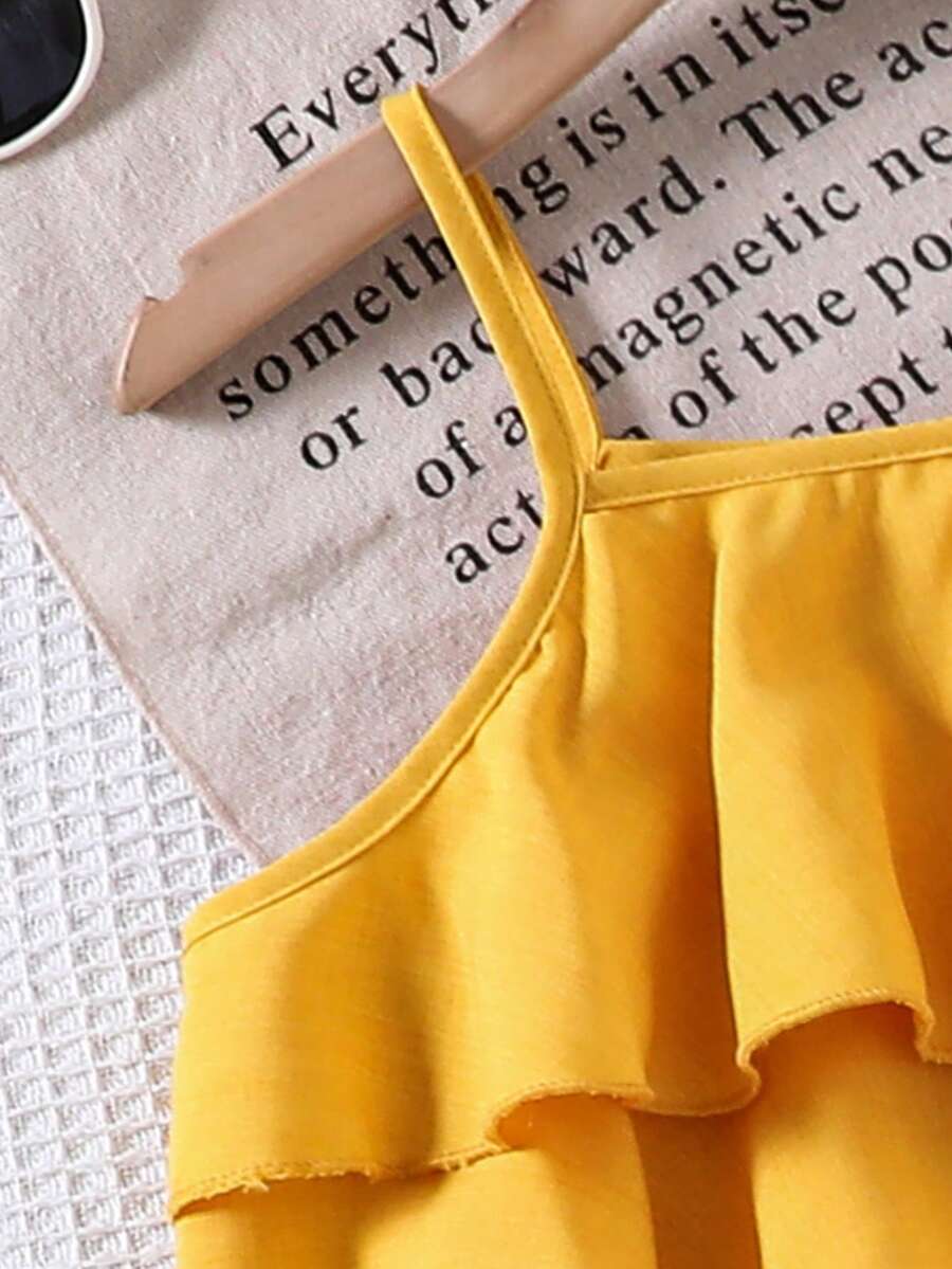 Tween girls blue 2-piece vacation outfit set featuring a tiered ruffle spaghetti strap camisole and loose high-waist pants.