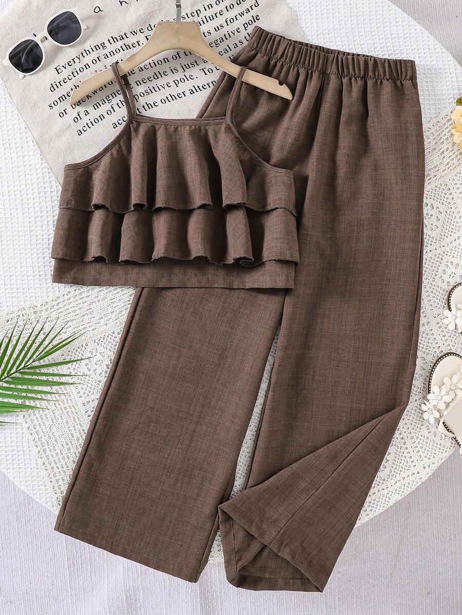 Tween girls blue 2-piece vacation outfit set featuring a tiered ruffle spaghetti strap camisole and loose high-waist pants.