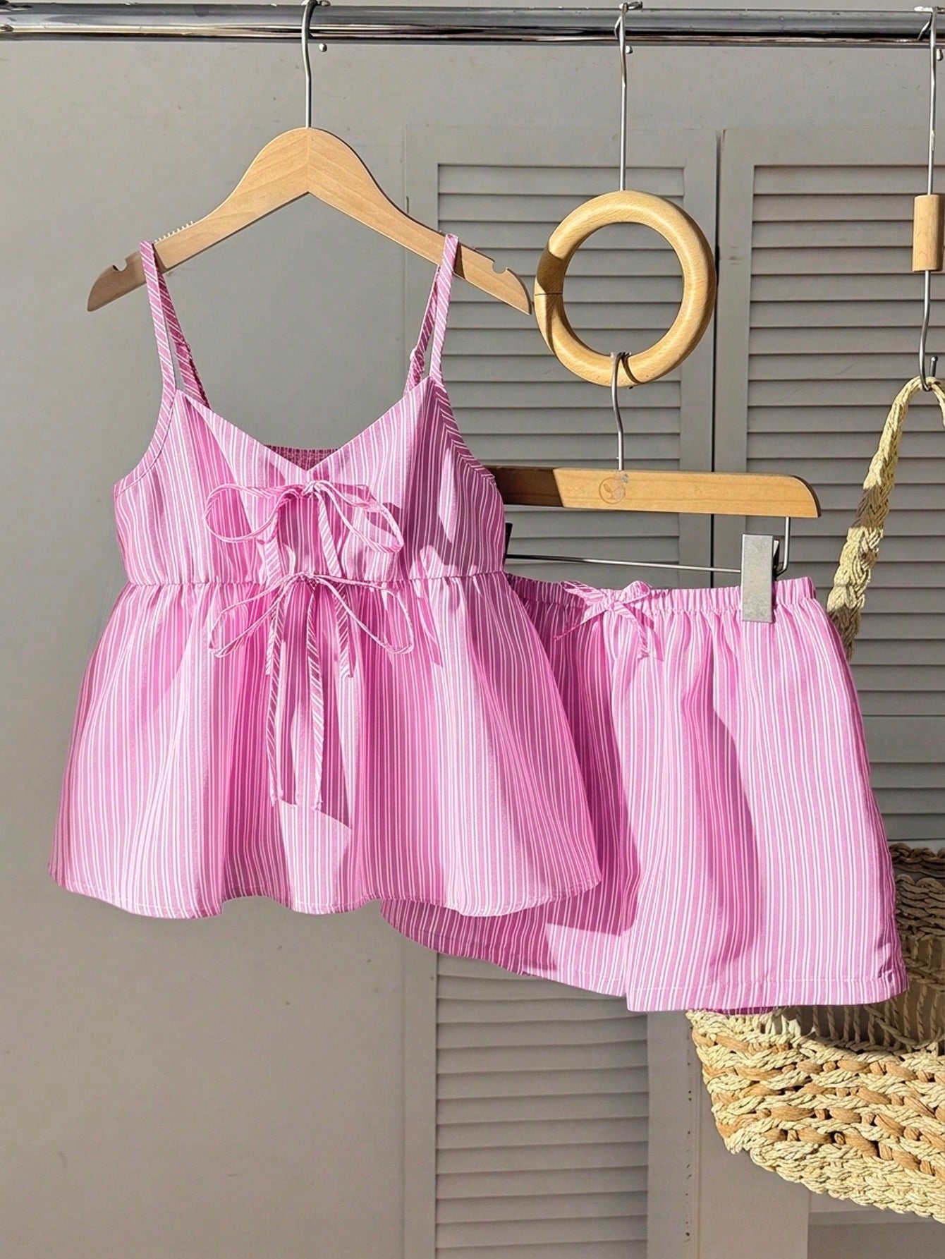 Tween girl 2-piece summer set with a black and white sleeveless striped spaghetti strap tank top with ruffle details and matching casual shorts.