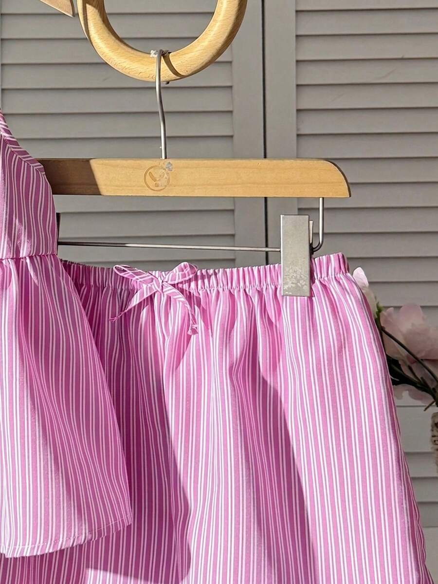Tween girl 2-piece summer set with a black and white sleeveless striped spaghetti strap tank top with ruffle details and matching casual shorts.