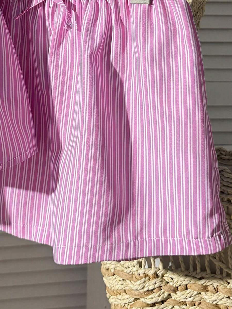 Tween girl 2-piece summer set with a black and white sleeveless striped spaghetti strap tank top with ruffle details and matching casual shorts.