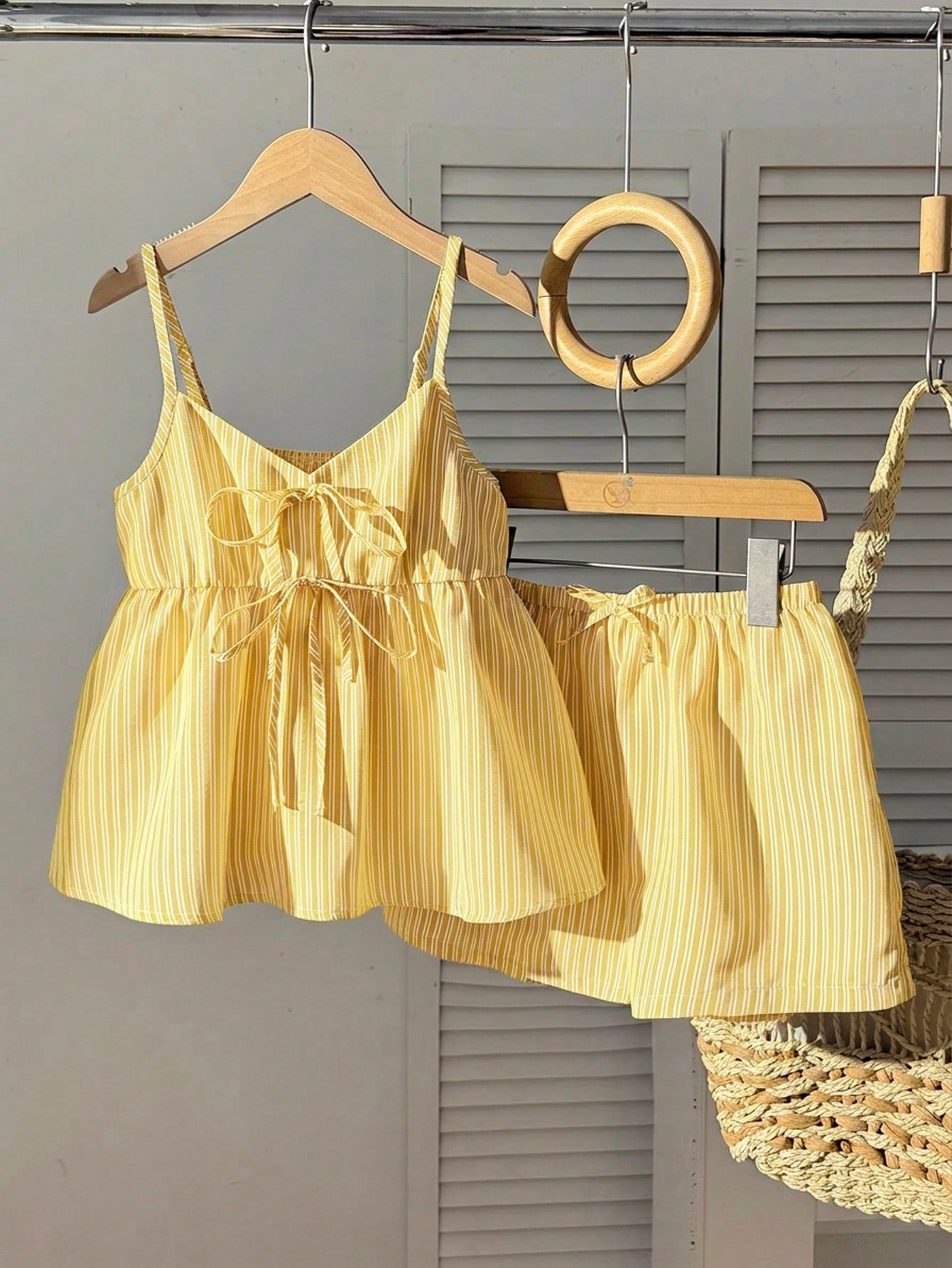 Tween girl 2-piece summer set with a black and white sleeveless striped spaghetti strap tank top with ruffle details and matching casual shorts.