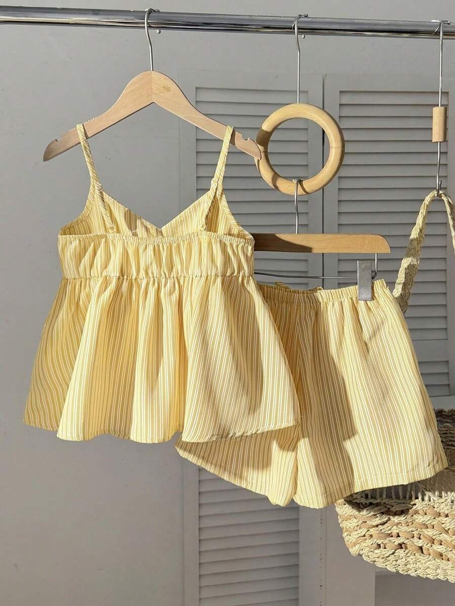 Tween girl 2-piece summer set with a black and white sleeveless striped spaghetti strap tank top with ruffle details and matching casual shorts.