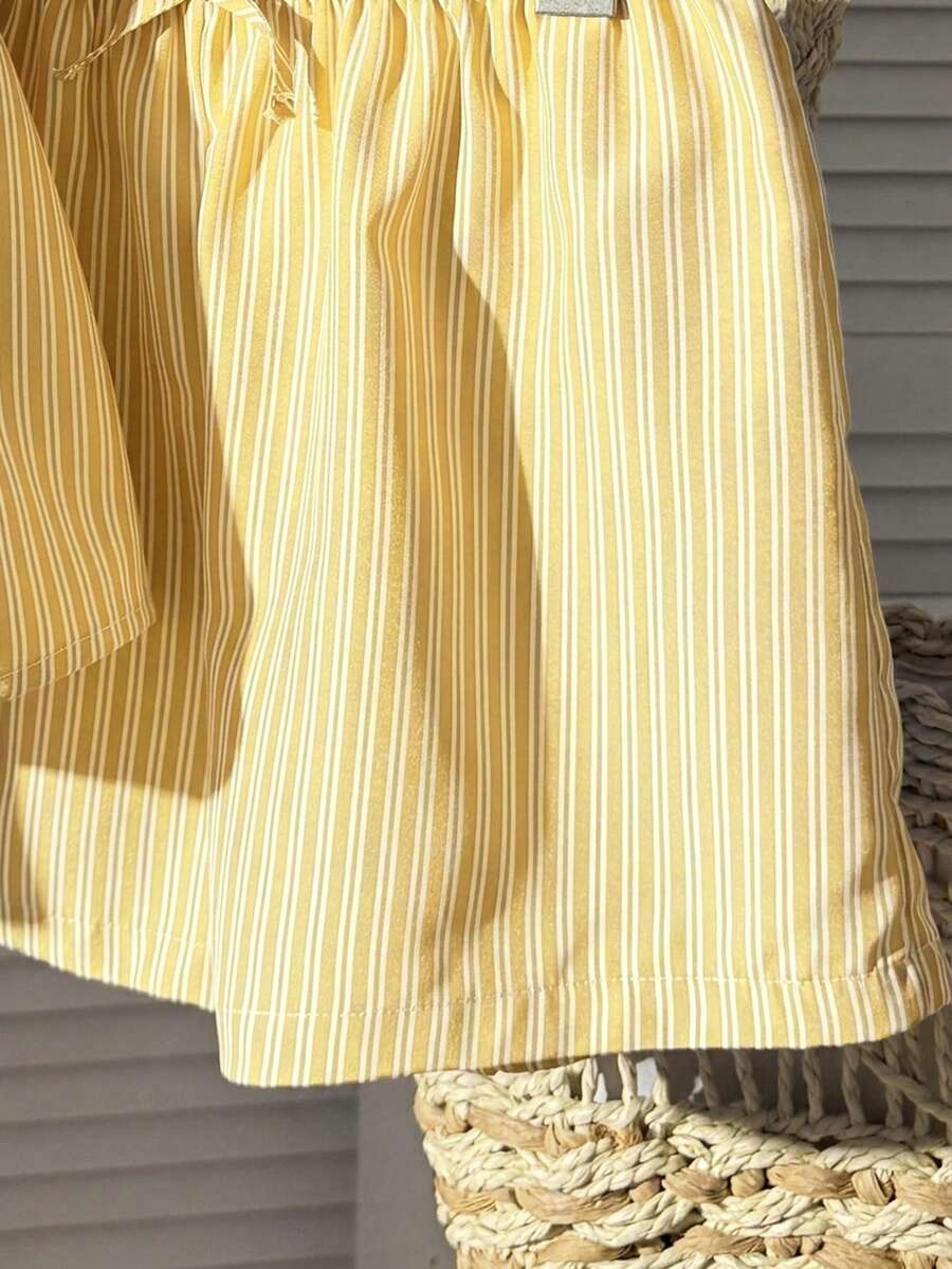 Tween girl 2-piece summer set with a black and white sleeveless striped spaghetti strap tank top with ruffle details and matching casual shorts.