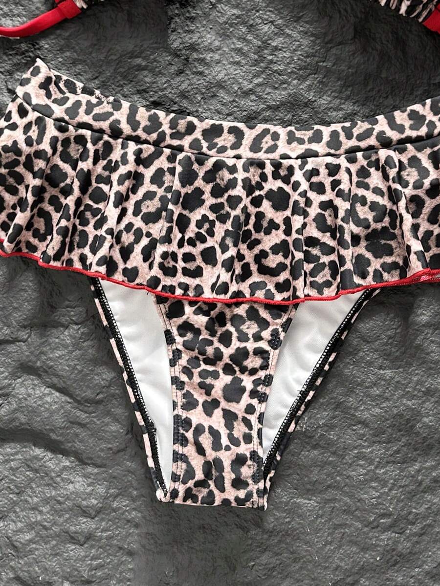 Women's 70s retro black and white polka dot bikini set featuring a halter triangle top and ultra low waist bottoms.