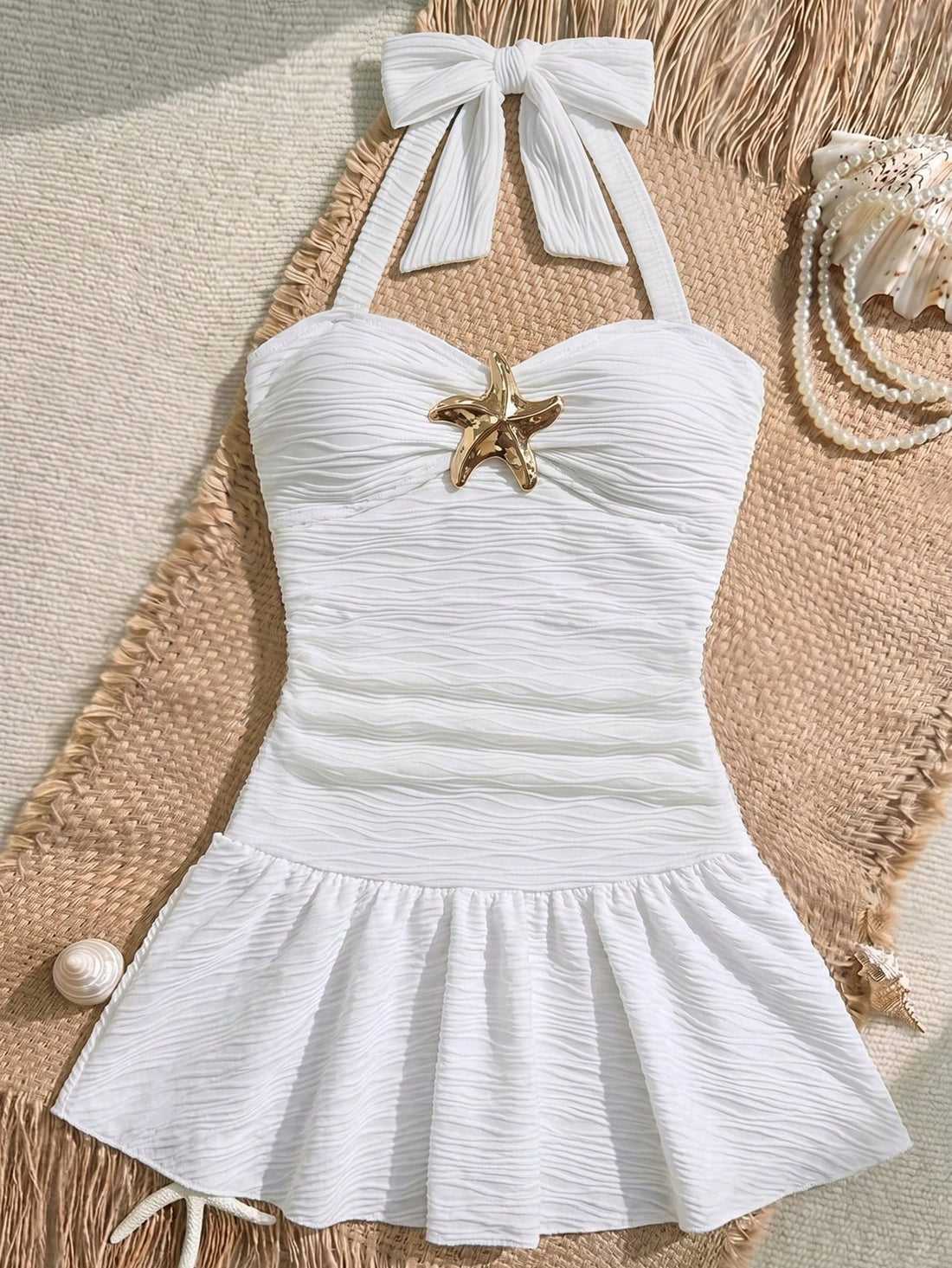White tween girls one-piece swimsuit with textured fabric, spaghetti straps, tie bow detail, halter style, and open back for summer beachwear.