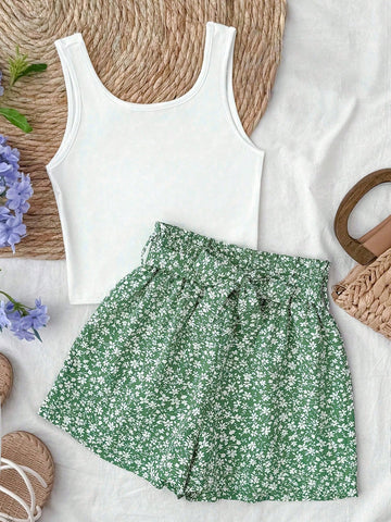 Tween girl summer two-piece outfit featuring a white scoop neck tank top and green ditsy floral print paperbag waist shorts with belt.