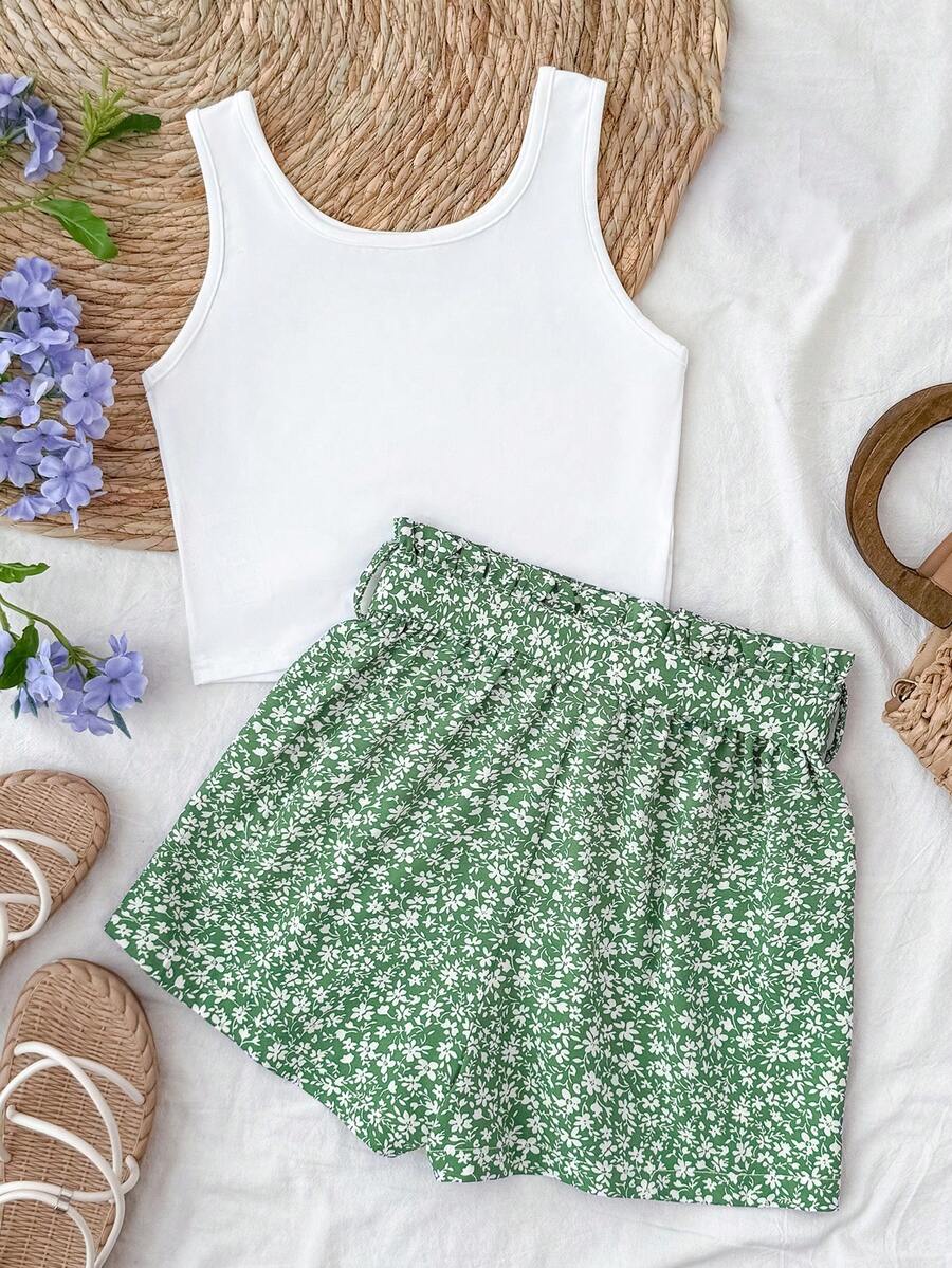 Tween girl summer two-piece outfit featuring a white scoop neck tank top and green ditsy floral print paperbag waist shorts with belt.