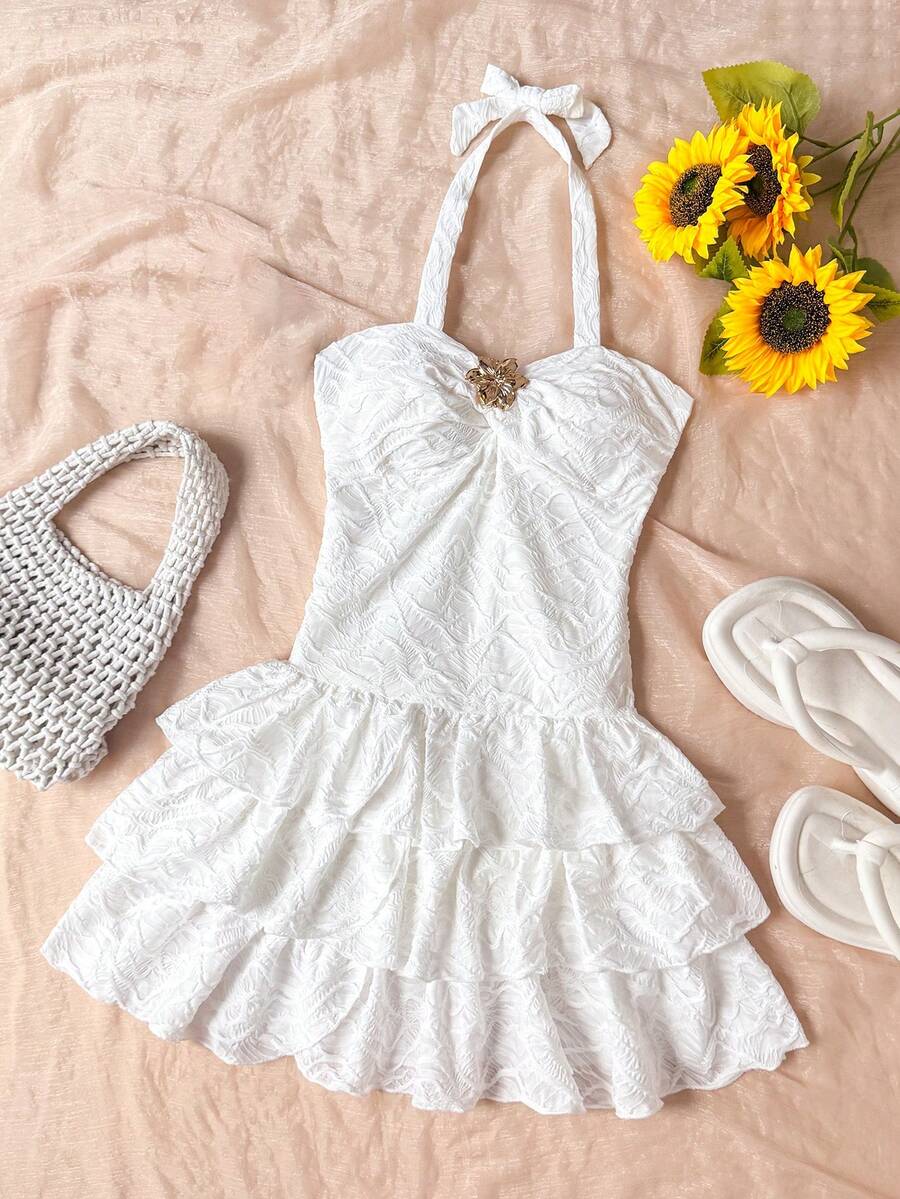Tween girls blue and white floral halter sundress with shirred detail, sleeveless cami style, high waist, and tiered ruffle hem for vacation wear