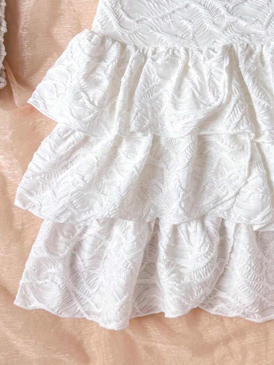 Tween girls blue and white floral halter sundress with shirred detail, sleeveless cami style, high waist, and tiered ruffle hem for vacation wear