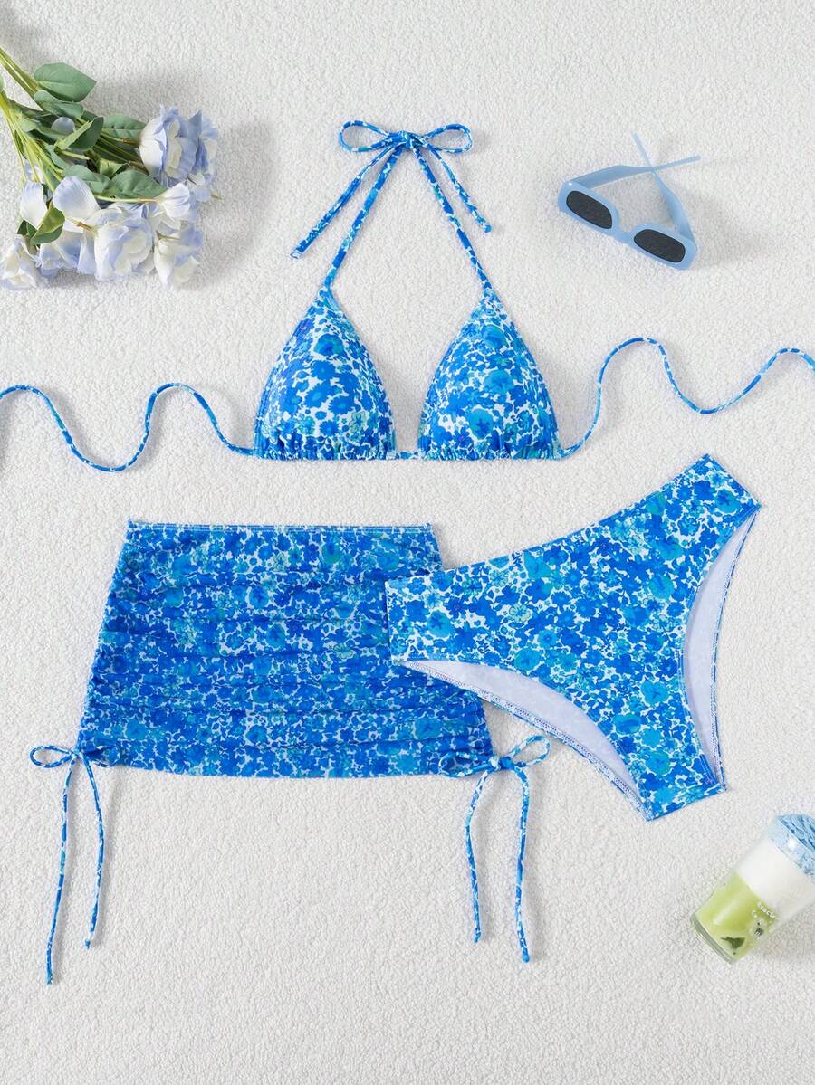 Women's black 3-piece bikini set featuring a halter triangle top with removable padding, high-waisted bottoms, and a knee-length mesh skirt with tie details.