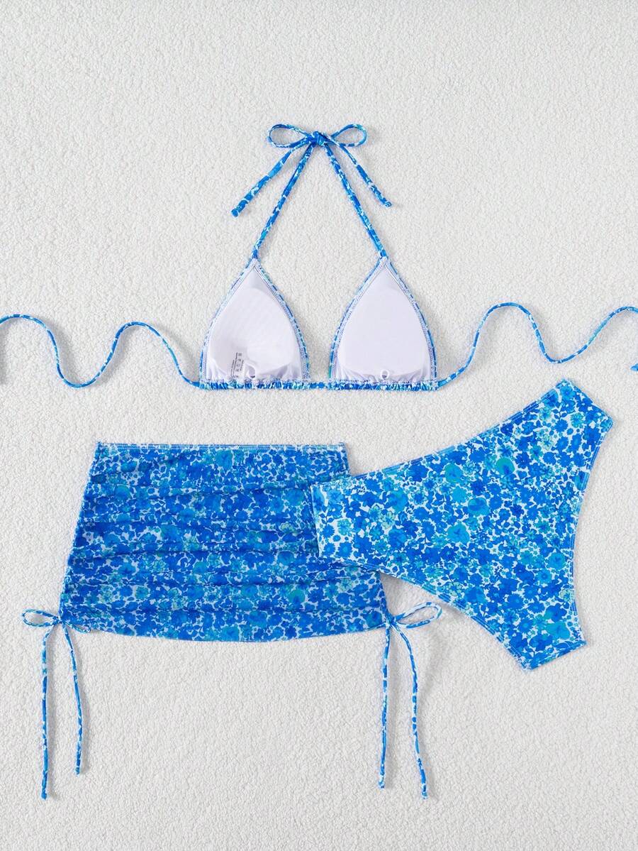 Women's black 3-piece bikini set featuring a halter triangle top with removable padding, high-waisted bottoms, and a knee-length mesh skirt with tie details.