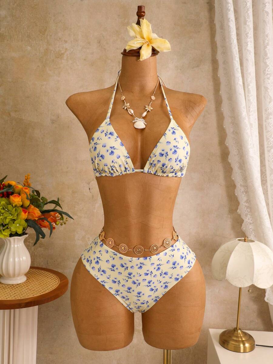 Women's black 3-piece bikini set featuring a halter triangle top with removable padding, high-waisted bottoms, and a knee-length mesh skirt with tie details.