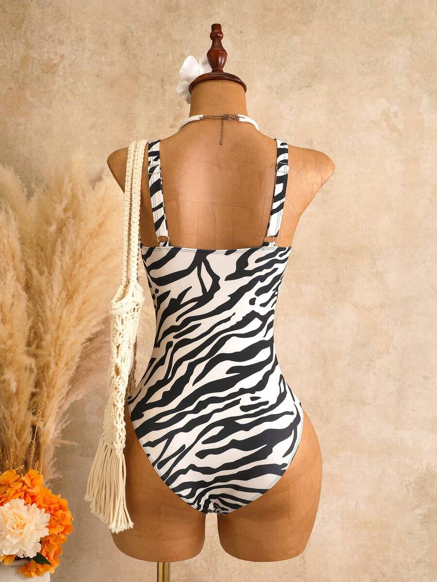 Women's black floral print plunge neck one-piece swimsuit featuring cut-out detail paired with a matching knee-length mesh cover-up skirt