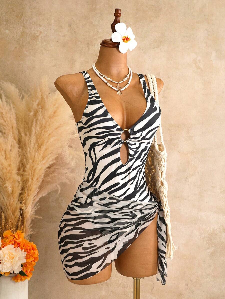 Women's black floral print plunge neck one-piece swimsuit featuring cut-out detail paired with a matching knee-length mesh cover-up skirt