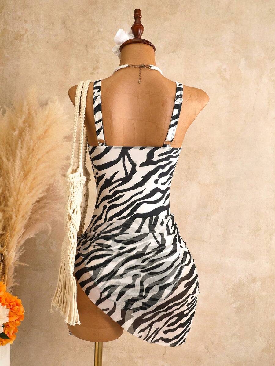 Women's black floral print plunge neck one-piece swimsuit featuring cut-out detail paired with a matching knee-length mesh cover-up skirt
