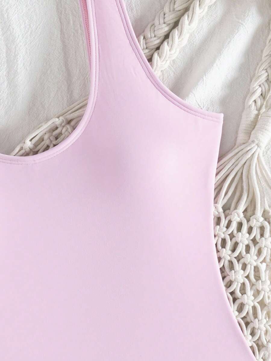 Women's solid color one-piece swimsuit featuring a backless scoop neck design and high cut fit