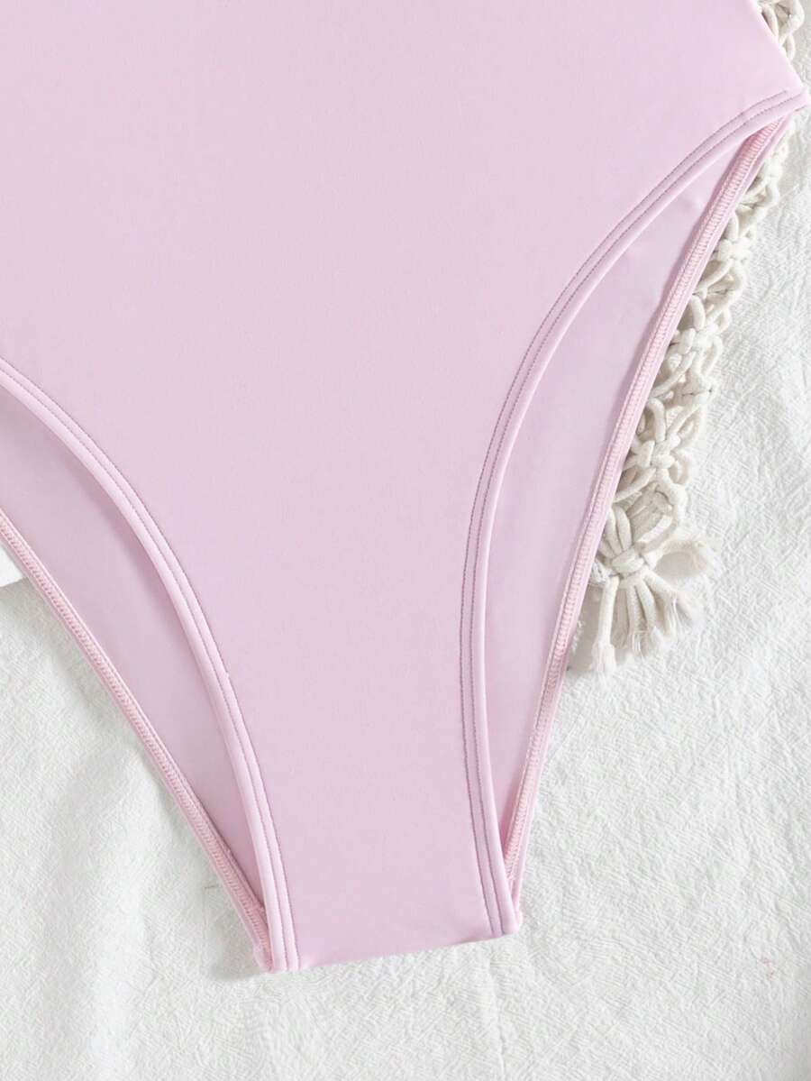 Women's solid color one-piece swimsuit featuring a backless scoop neck design and high cut fit