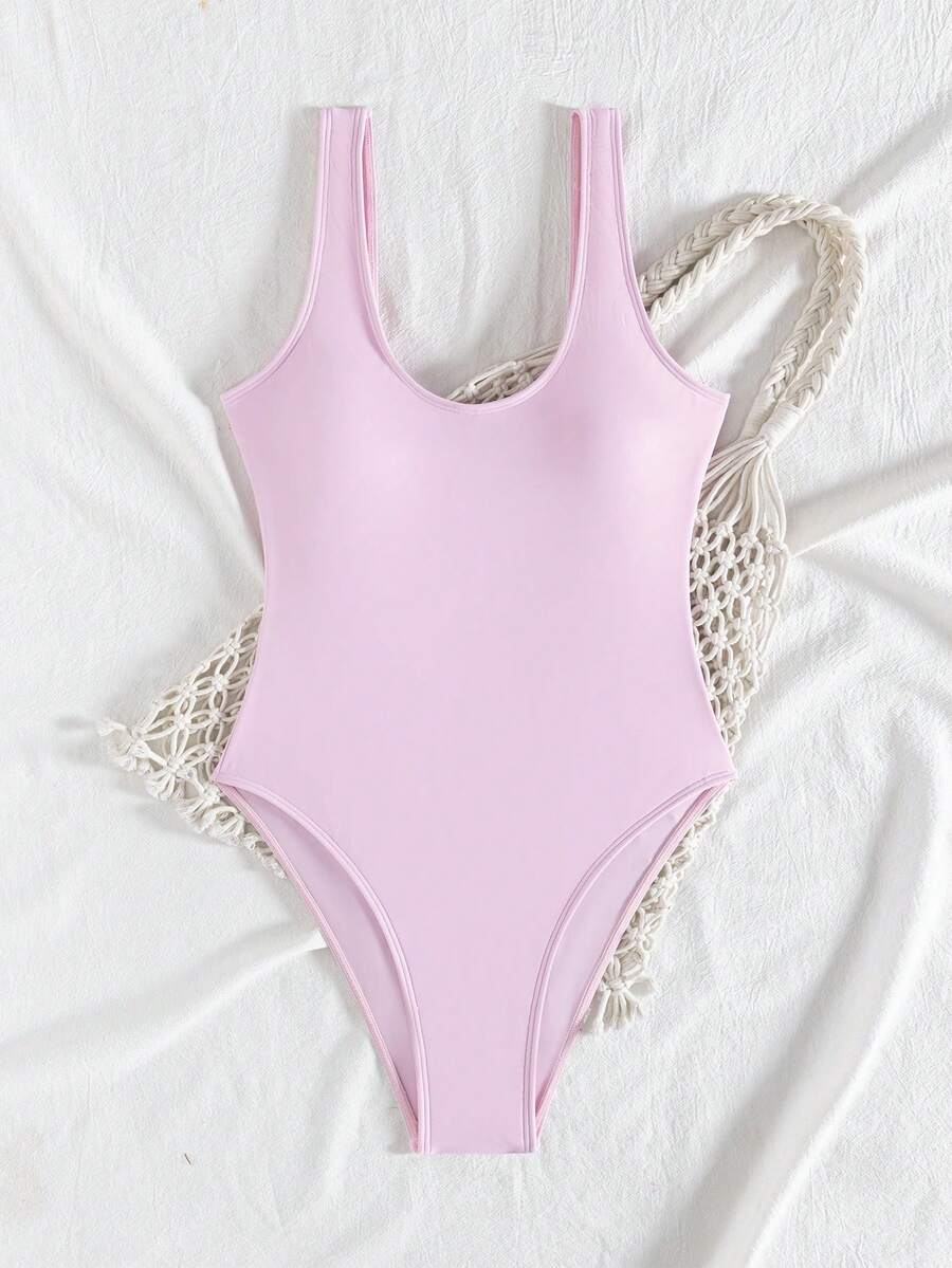 Women's solid color one-piece swimsuit featuring a backless scoop neck design and high cut fit