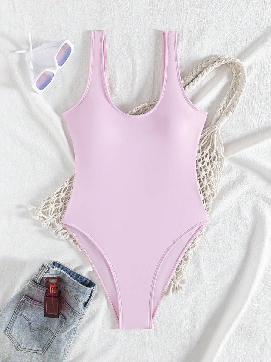 Women's solid color one-piece swimsuit featuring a backless scoop neck design and high cut fit