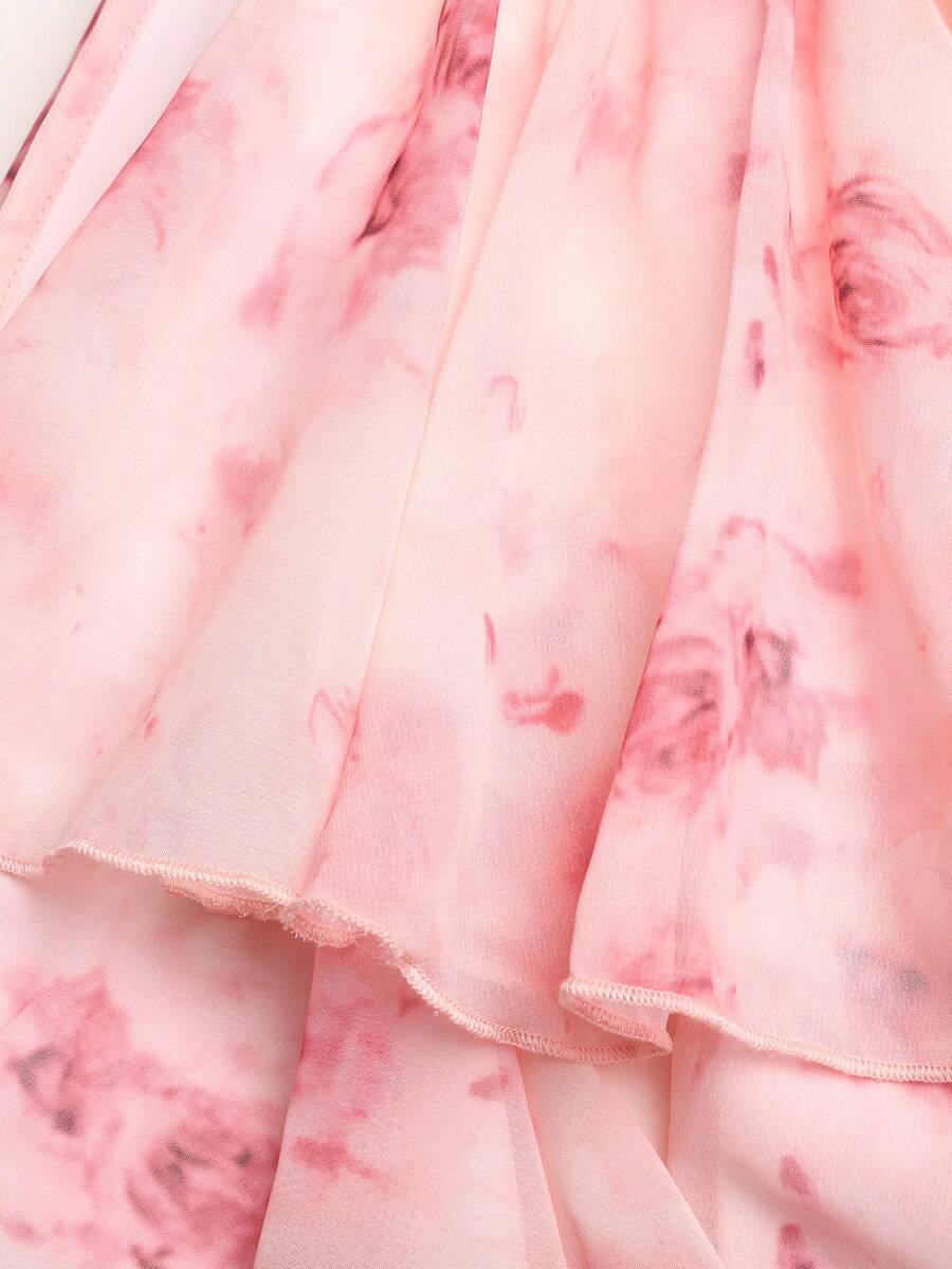 Apricot all-over floral print midi dress for tween girls featuring a sleeveless V-neckline, high waist, button details, and tiered A-line skirt.