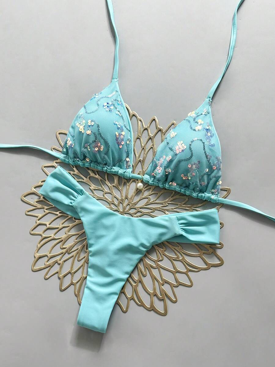 Women's 2-piece triangle cup bikini set in solid color featuring woven pearl shell decoration, halter neckline, and high-waist side-tie ruched bottoms.